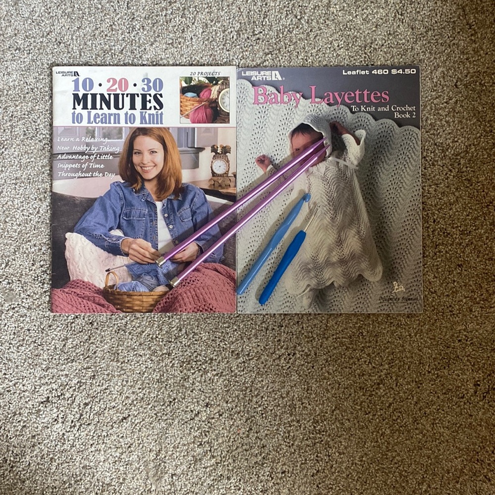 Two crocheting books with crocheting sticks, into crocheting hooks
